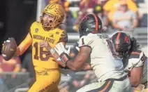  ?? ?? ASU quarterbac­k Trenton Bourguet scrambles from Oregon State linebacker Omar Speights on Saturday.