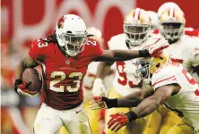  ?? Christian Petersen / Getty Images ?? Chris Johnson stiff-arms NaVorro Bowman on a fourthquar­ter run. Johnson finished with 110 yards and two TDs.