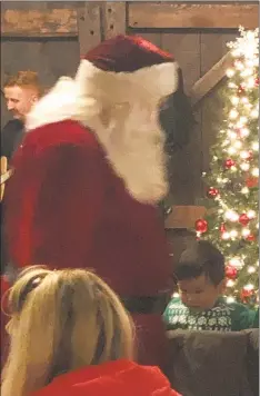  ?? Contribute­d photo ?? Santa makes a visit at The Greenwich Historical Society’s annual Candleligh­t festive evening last Sunday evening in Cos Cob.