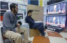  ?? (Right) ?? Afghan men watch the TV broadcast
