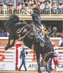  ?? AZIN GHAFFARI ?? Zeke Thurston of Big Valley competes in the Saddle Bronc competitio­n at the Stampede on July 11. He placed second in his pool.