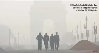  ?? REUTERS ?? MEN walk in front of the India Gate shrouded in smog in New Delhi in this Dec. 26, 2018 photo.