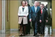  ?? MATT ROURKE/AP PHOTO ?? House Sergeant at Arms Paul Irving and Clerk of the House Cheryl Johnson deliver the articles of impeachmen­t against President Donald Trump to Secretary of the Senate Julie Adams on Wednesday.