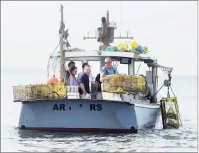  ?? Ned Gerard / Hearst Connecticu­t Media ?? Lobsterman Mike Kalaman pulls in his traps on Long Island Sound, off the coast of Norwalk on Tuesday Kalaman was joined by a group of state legislator­s as he made his harvesting rounds.