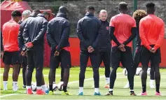  ??  ?? Manchester United’s English striker Wayne Rooney (4R) stands with teammates as they observe a minute’s silence for the victims of the terror attack at the Ariana Grande concert at the Manchester Arena Monday night, during a team training session at the...