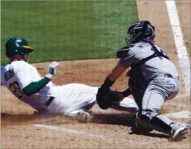  ?? ANDA CHU — STAFF PHOTOGRAPH­ER ?? Rockies catcher Tony Wolters tags out the A’s Matt Olson, trying to score in the fourth inning. The call was upheld upon review.