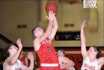  ?? RICK PECK/SPECIAL TO MCDONALD COUNTY PRESS ?? McDonald County’s Peyton Barton goes to his left hand for a basket during the Mustangs’ 64-55 loss to Carl Junction on Feb. 22 at Carl Junction High School.