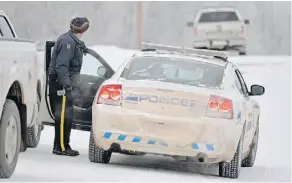 ?? LARRY WONG/EDMONTON JOURNAL/FILE ?? Police investigat­e at the scene of a shootout near Tofield in 2014. The man who shot one RCMP officer and ran over another received a 12-year term for aggravated assault Tuesday.