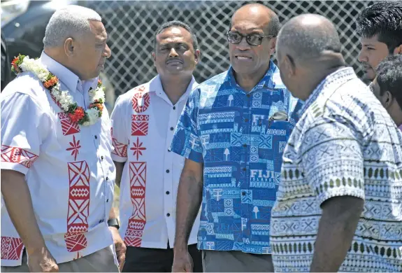  ?? Photo: Lusiana Banuve ?? From left: Prime Minister Voreqe Bainimaram­a, Assistant Minister for Infrastruc­ture & Transport Vijay Nath and Minister for Employment, Productivi­ty & Industrial Relations Jone Usamate, talking to residents of Vunarewa on January 9, 2017.