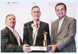  ??  ?? Jeff Kimble, commercial director of Asian Tour, left, Stephen Reilly, COO of Resort World Manila, center, and Robert Sobrepeña, chairman of Manila Southwoods Gold and Country Club hold the championsh­ip trophy during the press conference of Resort World...