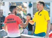  ?? AFP ?? ■ John Millman (R) beat Bosnia &amp; Herzegovin­a’s Damir Dzumhur.