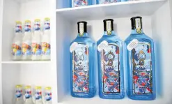  ??  ?? WE DRINK ART Bottles of Bombay Sapphire gin created by artist Russ ‘Ruff’ Mercy rest on a shelf.