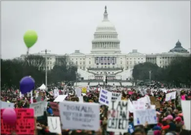  ?? JOHN MINCHILLO — ASSOCIATED PRESS ?? Protesters gather on the National Mall for the Women’s March on Washington during the first full day of Donald Trump’s presidency, Saturday in Washington, D.C.