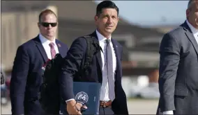  ?? J. SCOTT APPLEWHITE—ASSOCIATED PRESS ?? In this Aug. 18, 2020, file photo acting-secretary of Homeland Security Chad Wolf, center, arrives to join President Donald Trump at Andrews Air Force Base in Md. In December, U.S. officials discovered that federal agencies had fallen victim to a cyberespio­nage effort pulled off largely through a hack of Solarwinds software .The hackers accessed accounts belonging to then-acting Secretary Chad Wolf and staff at the Cybersecur­ity and Infrastruc­ture Security Agency who focus on finding cyber threats from nation-state adversarie­s like Russia, according to current and former senior Homeland Security Department and intelligen­ce officials who were briefed on the extent of the breach.