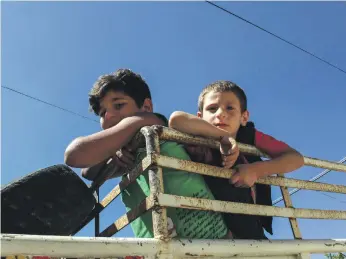  ?? AFP ?? Syrian refugees wait to be relocated from the southern Lebanese village of Shebaa to Syria