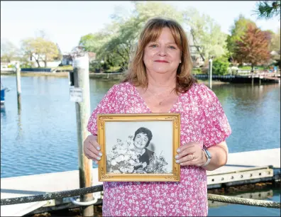  ?? ?? Patty Rogers, of North Kingstown holds a photo of her late mother, Mary Lutfring, in Wickford.