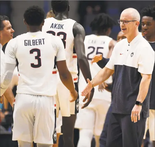  ?? Jessica Hill / Associated Press ?? UConn coach Dan Hurley greets Alterique Gilbert during a timeout in the first half of an October exhibition game in Hartford.