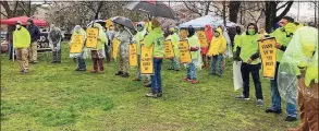  ??  ?? Local 326 of the Carpenter’s Union rally in Wooster Square Park in a teeming rainstorm Thursday as it called out companies that fail to pay workers’ compensati­on insurance and misclassif­y workers as independen­t contractor­s.