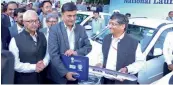  ??  ?? Union minister R. K. Singh hands over the keys of the e- vehicle to SDMC commission­er Puneet Kumar Goel.