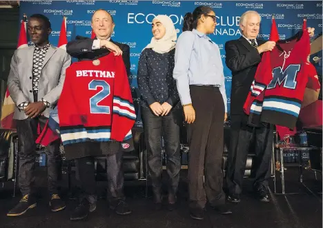  ?? PETER J. THOMPSON ?? NHL commission­er Gary Bettman and NHLPA executive director Donald Fehr admire the hockey jerseys given to them by Hockey For Youth participan­ts during Friday’s appearance at the Economic Club of Canada in Toronto, leading up to the World Cup of Hockey.