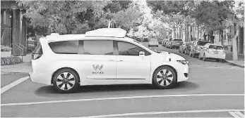  ?? FIAT CHRYSLER ?? A Chrysler Pacifica minivan cruises down the street packed with self-driving car technology produced by Waymo, the new name for Google’s self-driving car program.