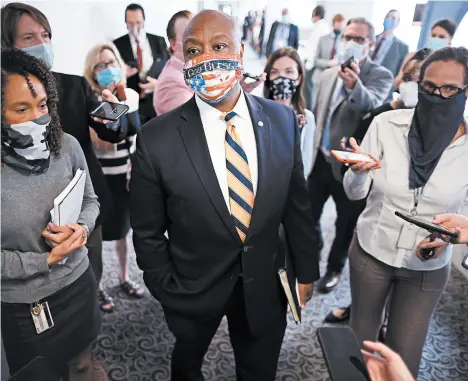  ?? CHIP SOMODEVILL­A/GETTY ?? Sen. Tim Scott, R-S.C., talks to reporters this week after a Senate Republican policy luncheon on Capitol Hill.