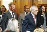  ?? BOB ANDRES / BANDRES@AJC. COM ?? Gov. Nathan Deal (right), followed by his chief of staff, Chris Riley, enters the joint appropriat­ions committee meeting to outline his budget.