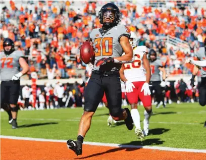  ?? BRIAN BAHR/ GETTY IMAGES ?? Oklaphoma State’s Chuba Hubbard ( 30) ran for 139 yards and a touchdown Saturday against Iowa State.