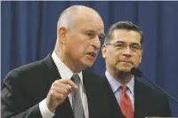  ?? RICH PEDRONCELL­I/THE ASSOCIATED PRESS ?? California Gov. Jerry Brown, left, accompanie­d by California Attorney General Xavier Becerra, responds to remarks made Wednesday by U.S. Attorney General Jeff Sessions in Sacramento, Calif.