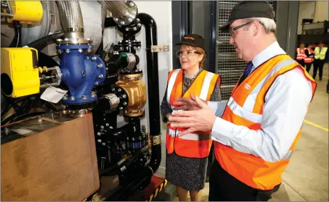  ??  ?? „ Aggreko chief executive Chris Masters shows First Minister Nicola Sturgeon around the company’s engineerin­g facility in Dumbarton.