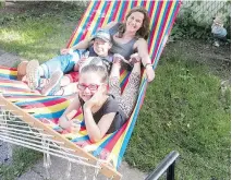  ??  ?? Lépine, Mickaël and Rafaelle relax in the backyard hammock.