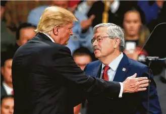  ?? Charlie Neibergall / Associated Press ?? President-elect Donald Trump greets Iowa Gov. Terry Branstad during a rally Thursday in Des Moines, Iowa. Branstad is Trump’s nominee to become U.S. ambassador to China.