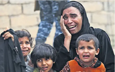  ??  ?? A family left homeless as Iraqi forces advance further into the city