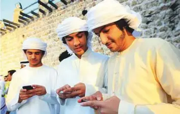 ?? Ahmed Ramzan/Gulf News Archives ?? Young men using their smartphone­s in Sharjah. WhatsApp registered its highest ranking among Emirati men, suggesting that the brand is ingrained into consumers’ daily actions beyond habitual behaviour. Picture used for illustrati­ve purposes only.