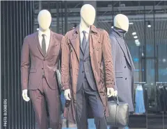  ??  ?? Mannequins displaying menswear and luggage stand at a Hugo Boss showroom in Metzingen, Germany, on Thursday.