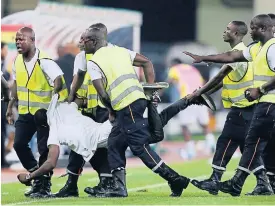  ??  ?? Fans disrupt the semi-final between Equatorial Guinea and Ghana.