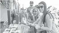  ?? ALEXIS MACKLIN ?? Meghan Scibienski and Abby Watts get tacos from The Market by Jennifer’s at last year’s Arizona Taco Festival at Salt River Fields at Talking Stick.