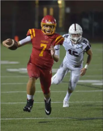  ?? PETE BANNAN — DIGITAL FIRST MEDIA ?? Haverford quarterbac­k Jake Ruane, running for a first down in the game against Garnet Valley two weeks ago, threw four touchdowns Saturday night, three of them to Shane Mosley, in a 40-16 statement win over previously unbeaten Radnor.