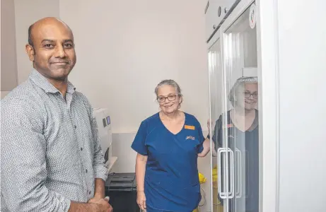  ?? Picture: Nev Madsen ?? VACCINE READY: Ochre Medical Centre Wyalla GP Harish Rangappa and enrolled nurse Toni Coad stand beside the GP clinic’s new fridge, which will be used to store the AstraZenec­a vaccine once it arrives.