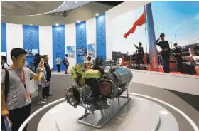  ?? Andy Wong / Associated Press 2017 ?? Visitors look at aircraft parts on display at Aviation Expo China in Beijing last year. Small aircraft are on the list of U.S. products that would be hit by tariffs.