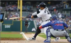  ??  ?? Detroit Tigers’ Victor Martinez hits a one-run single against the Chicago Cubs in the first inning of a baseball game in Detroit, on Tuesday. AP PHOTO/PAUL SANCYA