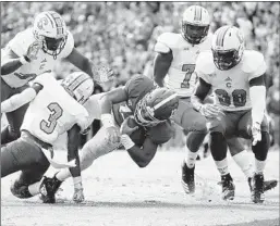  ?? KEVIN C. COX/GETTY ?? Alabama quarterbac­k Tua Tagovailoa finds a gap in the defense during the Tide’s win.