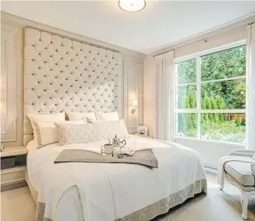  ??  ?? This bedroom has been fitted with a headboard that nearly reaches ceiling height.