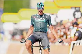  ?? Thomas Samson / Getty Images ?? Stage winner Team Bora Hansgrohe's Nils Politt of Germany celebrates as he crosses the finish line at the end of the 12th stage.