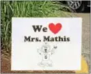  ?? LESLIE KROWCHENKO – DIGITAL FIRST MEDIA ?? “We Love Mrs. Mathis” signs line the school parking lot the day of the celebratio­n.