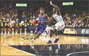  ?? Submitted photo ?? DUAL SHOCK: Louisiana Tech guard Amorie Archibald, left, dribbles down the lane against Wichita State guard Jamarius Burton (2) Tuesday during the Bulldogs’ 71-58 victory over the Shockers at the Charles Koch Arena in Wichita, Kansas. Photo by Kelly Ross, courtesy of Louisiana Tech Communicat­ions.