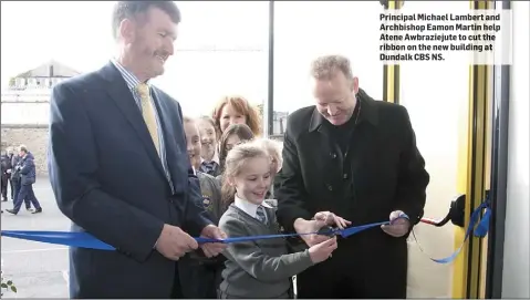  ??  ?? Principal Michael Lambert and Archbishop Eamon Martin help Atene Awbrazieju­te to cut the ribbon on the new building at Dundalk CBS NS.