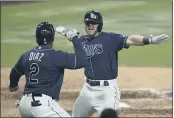  ?? JAE C. HONG — THE ASSOCIATED PRESS ?? The Rays’ Michael Brosseau, right, celebrates with Yandy Diaz after hitting a solo home run during the eighth inning of Game 5of the ALDS on Friday in San Diego.