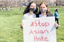  ?? DON STACOM/HARTFORD COURANT ?? High school student Natalie DeLaCruz of West Hartford, left, stands with her mother, Laura, at a rally Saturday against anti-Asian racism. The gathering at Hartford’s Bushnell Park included about 10 speakers, including DeLaCruz.