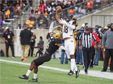  ?? (Special to The Commercial/Brian Tannehill) ?? UAPB receiver Dalyn Hill catches a pass with one hand over Alabama State defensive back Jacquez Payton and runs the rest of the field for a 70-yard touchdown in the fourth quarter of Saturday’s 35-15 loss in Montgomery, Ala.